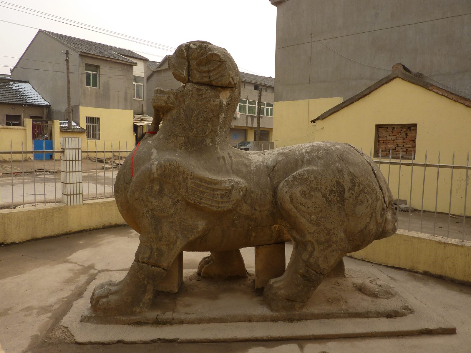 Stone qilin statue at the Chuning Mausoleum near Nanjing, tomb of Liu Yu, Emperor Wu of the Liu Song, fifth century stone standing in grass.
