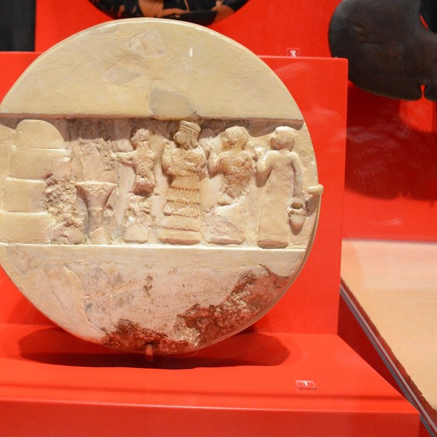 The Disk of Enheduanna, a calcite disk from Ur, showing the high priestess in ritual. An ancient object; the 1969 event is a modern scholarly edition of forty-two temple hymns.